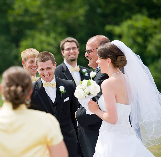 istock Joyous groom laughing as father presents bride 164933281