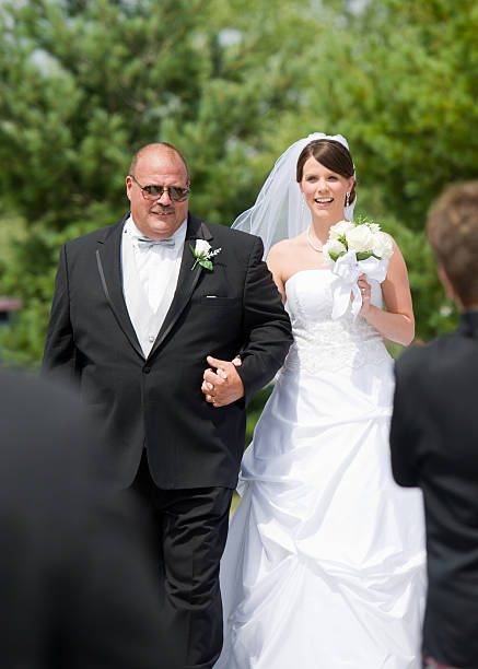 istock Father walks bride down the isle at outdoor wedding 164933298