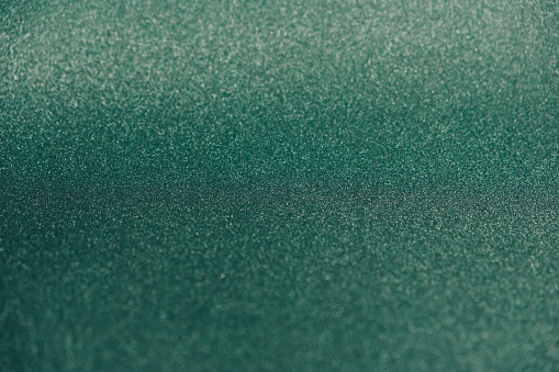 Green glitter texture Christmas abstract background, de-focused