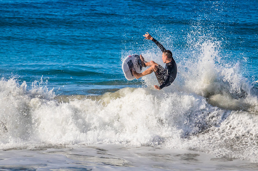 Puerto Escondido, Oaxaca August 31 2023 surfer man jumping with his board over a wave in zicatela puerto escondido oaxaca