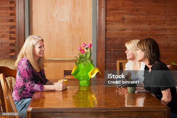 Two Generations Of Mature Women Talk Over Coffee Stock Photo - Download Image Now - 30-39 Years, 60-69 Years, Active Seniors