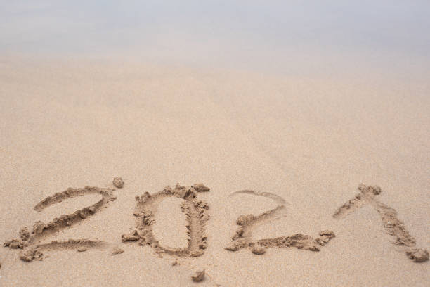 istock 2021 is on the sand. Drawing in the sand. 1649379651