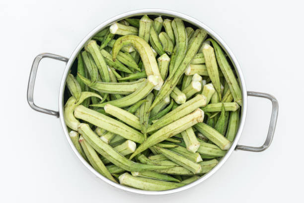 Fresh okra on the metallic pot.