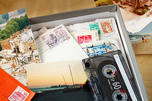 Box filled with memories Box filled with letters and photos. Photos where taken in Paris, and on the beach of the Mediterranean Sea. (Near Agde, France) audio cassette photos stock pictures, royalty-free photos & images