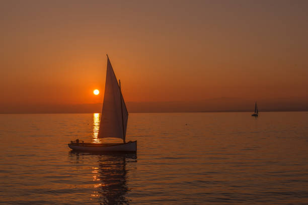 istock Sailboat sailing on a lake at the sunset. 1649428240