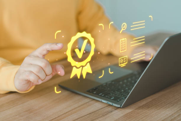 istock User using a laptop with virtual screen assessment sign of the top service quality assurance certificate for industrial and business. Guarantee, Standard, ISO certification concept. 1649446094