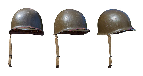 Vintage World War II United States army helmets at various angles isolated on a white background