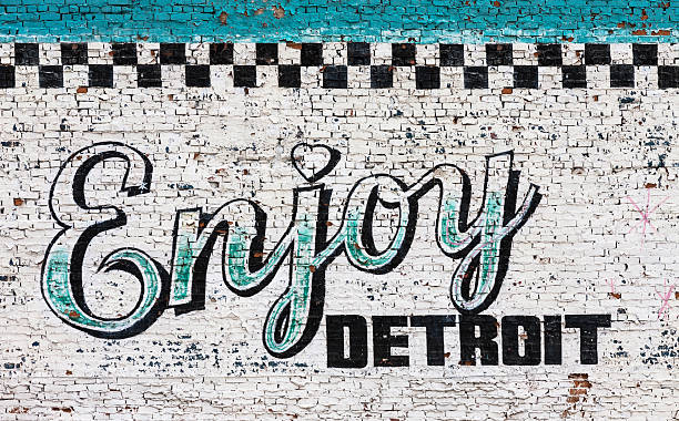 Enjoy Detroit sign on wall Enjoy Detroit sign on wall. detroit michigan stock pictures, royalty-free photos & images