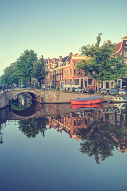 istock Amsterdam buildings reflected in water canal 164949376