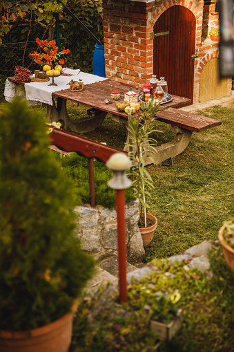 High angle view of a small, cozy corrner with a table decorated for autumn in the back yard.