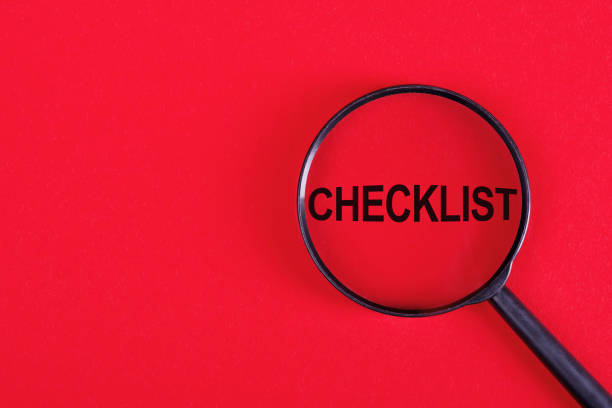 istock The word Checklist written on a magnifying glass on red background. 1649529752
