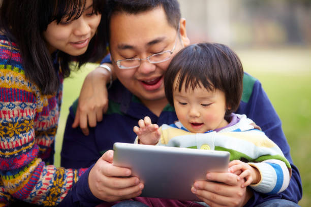istock happy family using tablet together outdoor 164954686