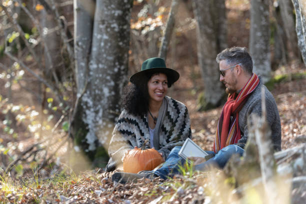 istock Couple sitting in nature. 1649551431