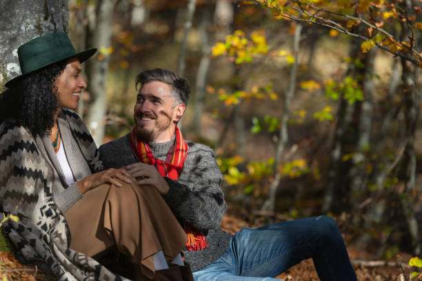 istock Couple sitting in nature. 1649551443
