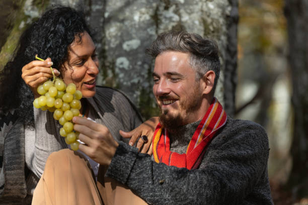 istock A couple eats grapes on a picnic in nature. 1649551460