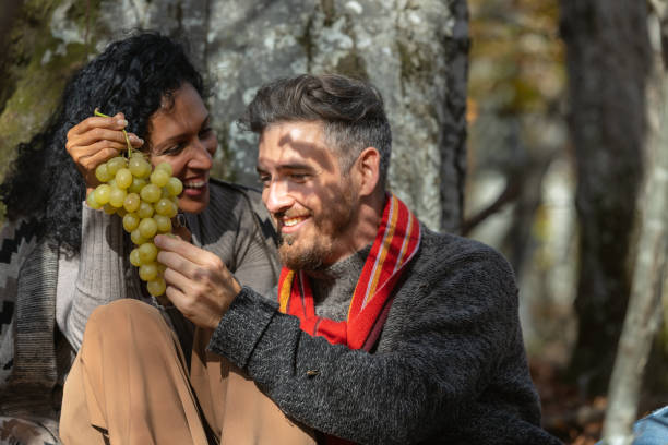 istock A couple eats grapes on a picnic in nature. 1649551462