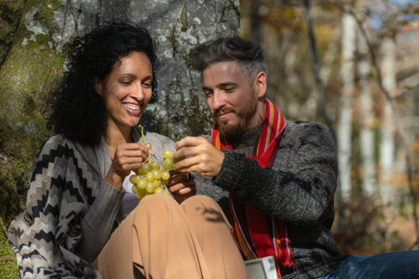 istock A couple eats grapes on a picnic in nature. 1649551489