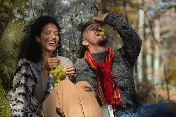 istock A couple eats grapes on a picnic in nature. 1649551494