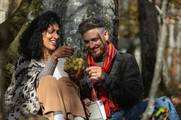 istock A couple eats grapes on a picnic in nature. 1649551503