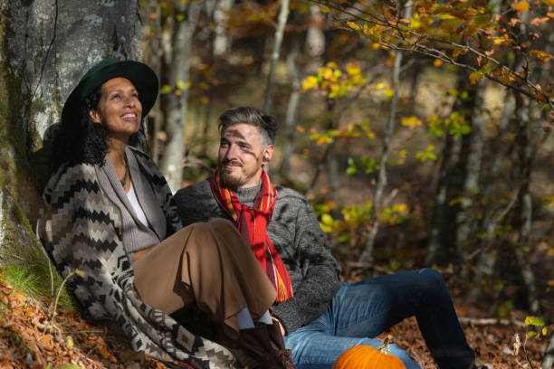 istock Couple sitting in nature. 1649551546
