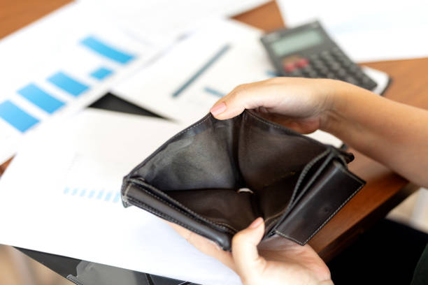 istock Poor woman hand open empty purse looking for money 1649554411