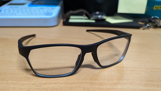 Photo of a pair of glasses on a wooden table