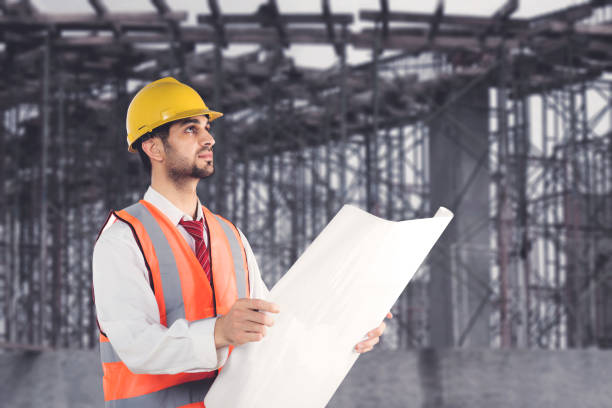 istock male architect checking a blueprint while standing near construction site 1649584020