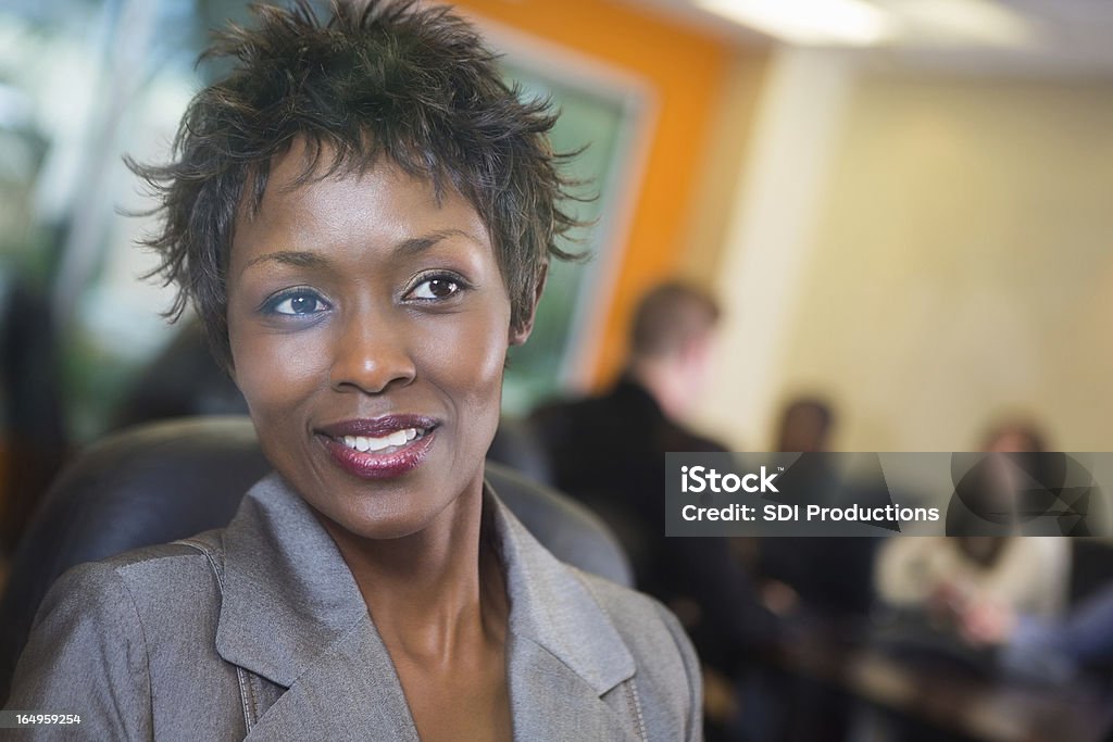 Pretty Woman Looking out conference room window during business meeting Pretty and Happy Woman Looking out conference room window during business meeting.  Adult Stock Photo