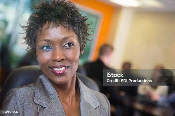 Pretty Woman Looking Out Conference Room Window During Business Meeting Stock Photo - Download Image Now