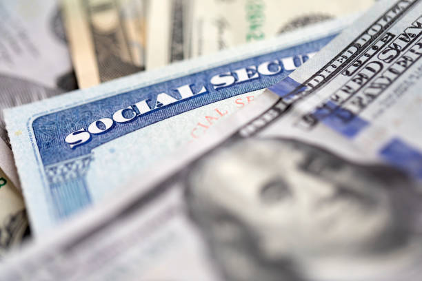 Social security card with money Social security card with US currency. Retirement benefit concept social security social security card identity us currency stock pictures, royalty-free photos & images