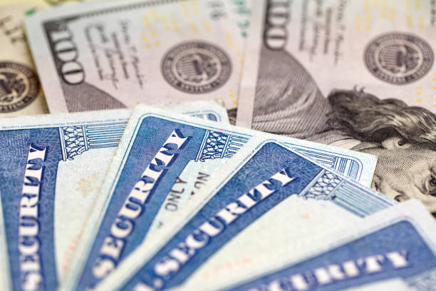 Social security card with money Social security card with US currency. Retirement benefit concept social security social security card identity us currency stock pictures, royalty-free photos & images