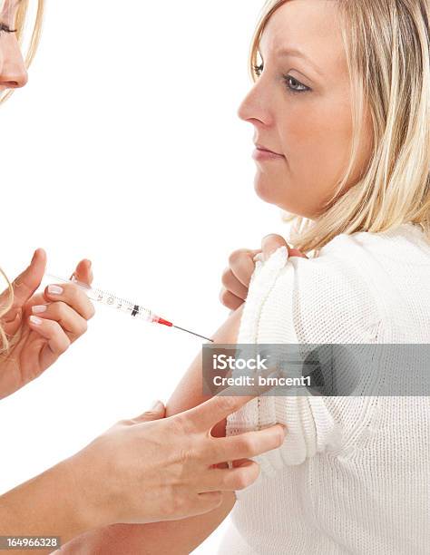 Nurse Giving A Female Patient An Injection In Her Arm Stock Photo - Download Image Now