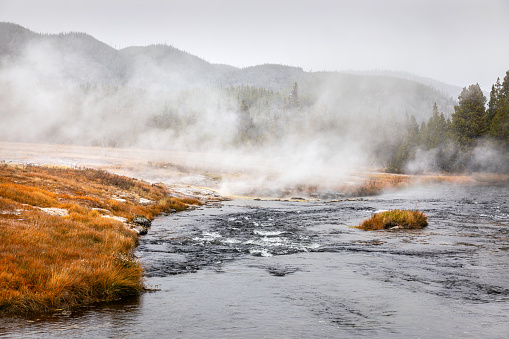 Colorful geyser erupting at Biscuit Basin in Yellowstone National Park.