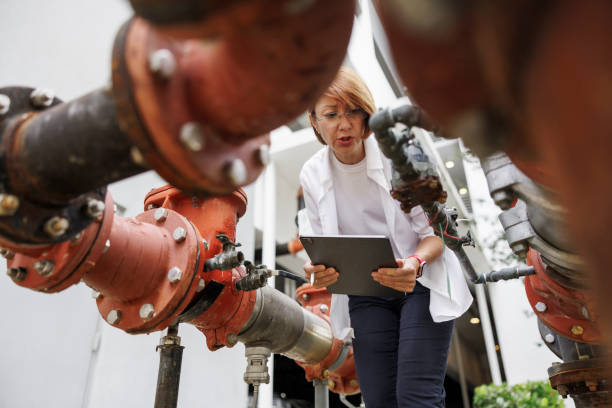 istock Assessing water infrastructure for claim compensations: claim agent, woman in glasses investigating damage and impact on water supply and sanitation outdoors. Low angle 1649701189