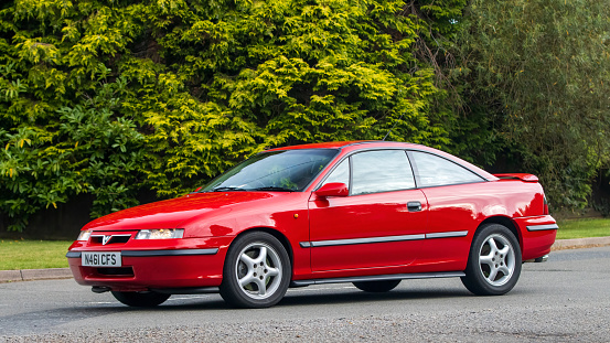 Whittlebury,Northants,UK -Aug 27th 2023: 1995 red Vauxhall Calibra car travelling on an English country road