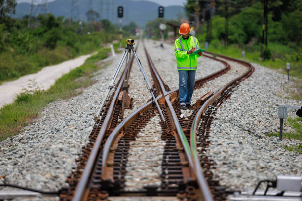 istock Engineer use theodolite equipment surveying construction worker on Railway site. 1649704366