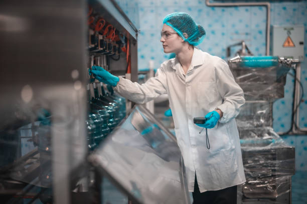 istock Water production team uses barcode scanners to ensure accurate bottle arrangement under guidance 1649748131