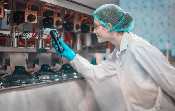 istock Water production team uses barcode scanners to ensure accurate bottle arrangement under guidance 1649757766