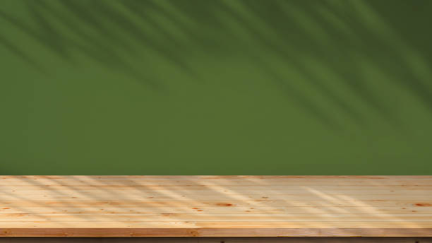 istock Empty wood counter on dark green interior wall background with sunlight and branch shadow on surface 1649761952