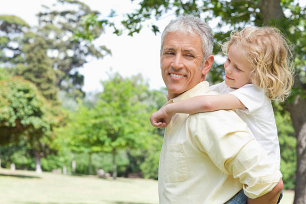 istock Father and son looking at each other side during piggy-back 164978326
