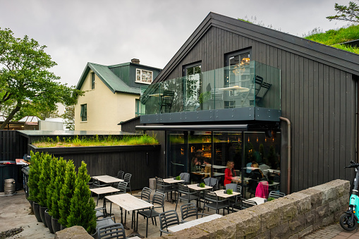People dine inside a restaurant in downtown Reykjavik, Iceland on an overcast day.