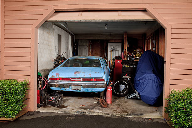 istock Small cluttered home garage viewed from the driveway 164979985