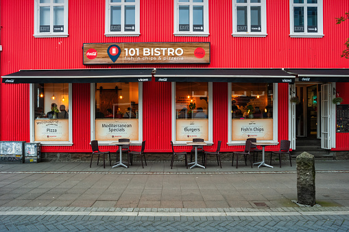 People dine inside a bistro-restaurant in downtown Reykjavik, Iceland on an overcast day.