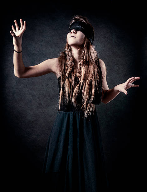 confused blindfolded woman on a white background Stock Photo