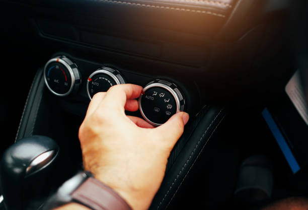 istock The driver hand adjusts the wind direction switch on a car air conditioning dashboard, turning button switch of a car air conditioning on a switch panel control. 1649820012