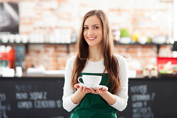 istock Waitress holding cup of coffee in cafe 164982592