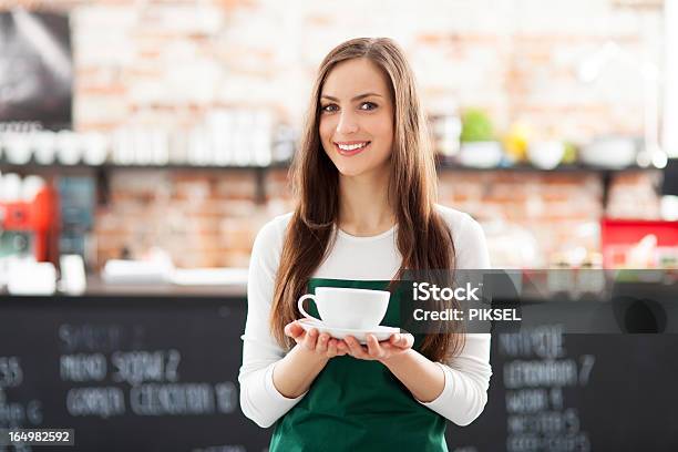 Waitress Holding Cup Of Coffee In Cafe Stock Photo - Download Image Now - Adult, Adults Only, Apron