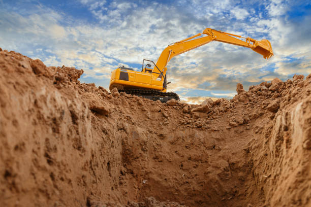 istock Yellow excavators are digging the soil in the construction site . 1649835333