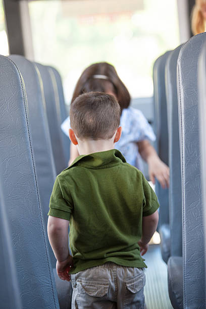 istock Kindergarten Boy walks up Isle of School Bus 164984014