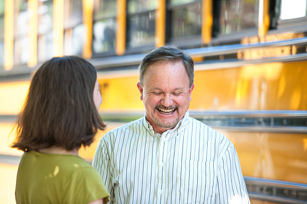 Parents have a laugh at the bus stop